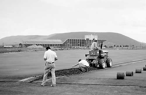 J. Duich overseeing installation of irrigation system