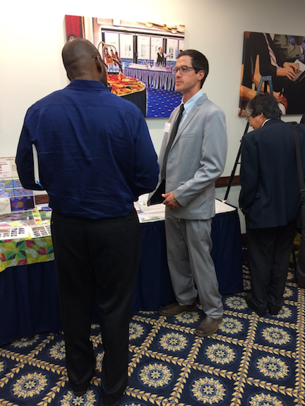 Jimmy Burridge, project coordinator, speaks to a USAID representative at the annual Legume Innovation Lab meeting in Washington D.C. September 12, 2017. Explaining the project's work to representative of various governmental organizations is important so they can in turn communicate the important of agricultural research to policy makers. 