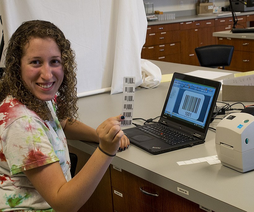 Stephanie Klein shows an example of bar-coded labels for her root sampling vials.