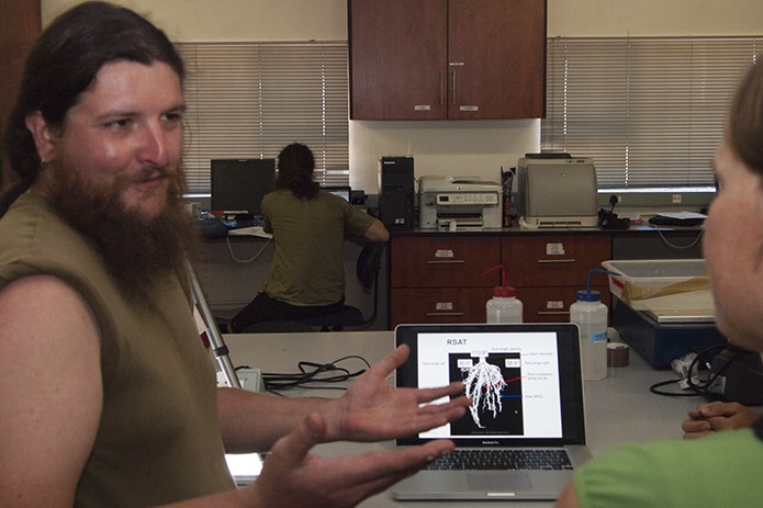 Visiting Swiss researcher, Atilla, demonstrates an automated root image analysis program. Photo courtesy of Bob Snyder.